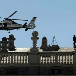 Un helicóptero Eurocopter AS365 "Dauphin" de la Guardia Civil española sobrevuela a los agentes que montan guardia en la azotea del Palacio Real de Madrid, durante la cumbre de la OTAN. ÓSCAR DEL POZO / AFP | Foto:AFP