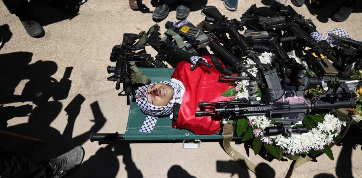 Los dolientes palestinos rodean el cuerpo de Mohammad Hamad, de 16 años, quien sucumbió a sus heridas, horas después de que soldados israelíes le dispararan en la aldea de Silwad, en Cisjordania, durante su funeral en la misma aldea. ABBAS MOMANI / AFP