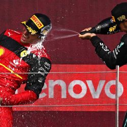 El piloto británico de Mercedes, Lewis Hamilton, rocía con champán al piloto español de Ferrari, Carlos Sainz Jr. en el podio de ganadores después del Gran Premio de Gran Bretaña de Fórmula Uno en el circuito de carreras de Silverstone, de Inglaterra. Ben Stansall / AFP. | Foto:AFP