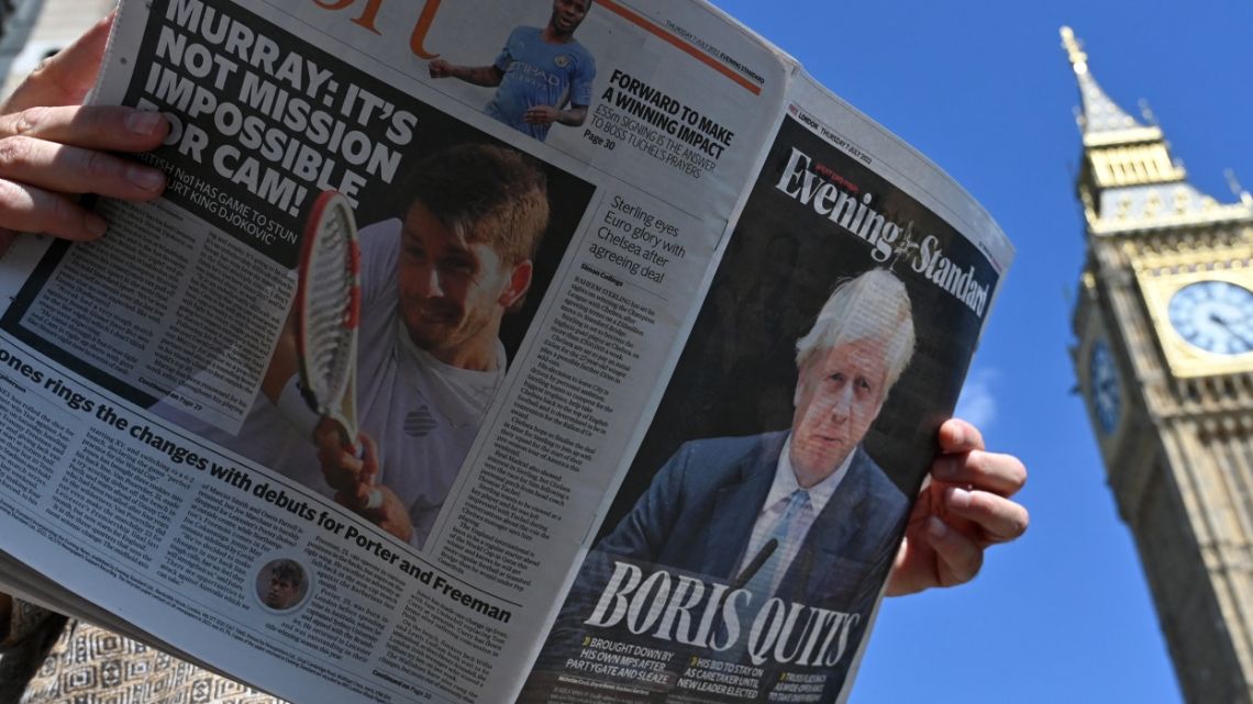A member of the public holds a copy of the Evening Standard newspaper, leading with story that Britain's Prime Minister Boris Johnson has resigned as leader of the Conservative Party, by the Houses of Parliament in central London on July 7, 2022. Boris Johnson resigned on Thursday as leader of Britain's Conservative party, paving the way for the selection of a new prime minister after dozens of ministers quit his government over 48 hours of frenzied political drama.