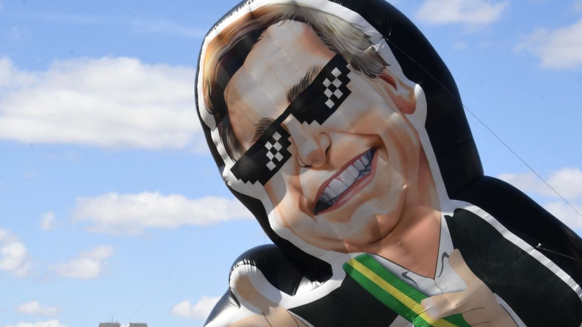 View of an inflatable doll depicting Brazilian President Jair Bolsonaro during a pro-arms demo called by his son, lawmaker Eduardo Bolsonaro, in Brasilia, on July 9, 2022.