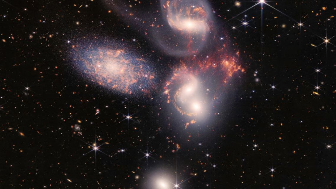 This image released by NASA on July 12, 2022, shows Stephan’s Quintet captured by the James Webb Space Telescope (JWST), a visual grouping of five galaxies, in a new light. This enormous mosaic is JWST’s largest image to date, covering about one-fifth of the Moon’s diameter. It contains over 150 million pixels and is constructed from almost 1,000 separate image files. The JWST is the most powerful telescope launched into space and it reached its final orbit around the sun, approximately 930,000 miles from Earths orbit, in January, 2022. The technological improvements of the JWST and distance from the sun will allow scientists to see much deeper into our universe with greater detail. 