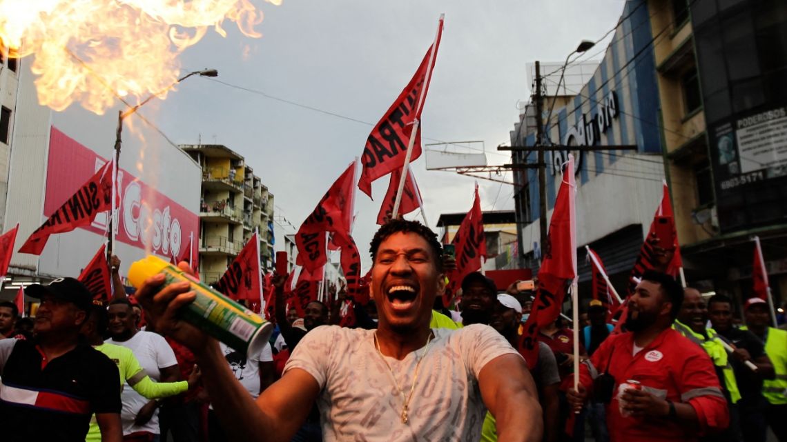 A protester sprays fire during a march against the high cost of food and gasoline in Panama City, on July 12, 2022. Despite the government's announcement on a solution to the population's petitions, thousands of people marched on Tuesday against rising product prices and corruption in Panama.