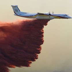 Un avión Bombardier Dash 8-Q400MR de Seguridad Civil lanza retardante de incendios sobre un incendio forestal cerca de Gignac, en el sur de Francia, mientras el país soporta un verano seco con incendios forestales que destruyen numerosos bosques en toda Francia. | Foto:Sylvain Thomas / AFP