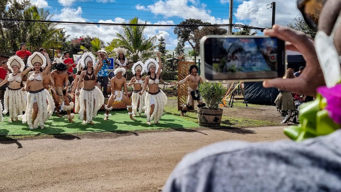 Workers of the Mataveri international ariport greet tourists on their arrival to Hanga Roa, Easter Island, Chile, on August 4, 2022. A first flight with tourists, mostly with reservations made before the pandemic was declared at the beginning of 2020, will arrive on Thursday at the Mataveri international airport, in Hanga Roa, informed the Undersecretary of Tourism, Verónica Kunze, to local media. 