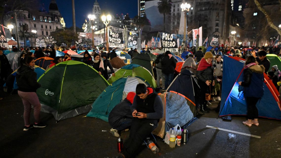 Members of social organisations grouped together under the Unidad Piquetera banner camp out during a protest at Plaza de Mayo square in front of Casa Rosada in Buenos Aires on August 10, 2022.