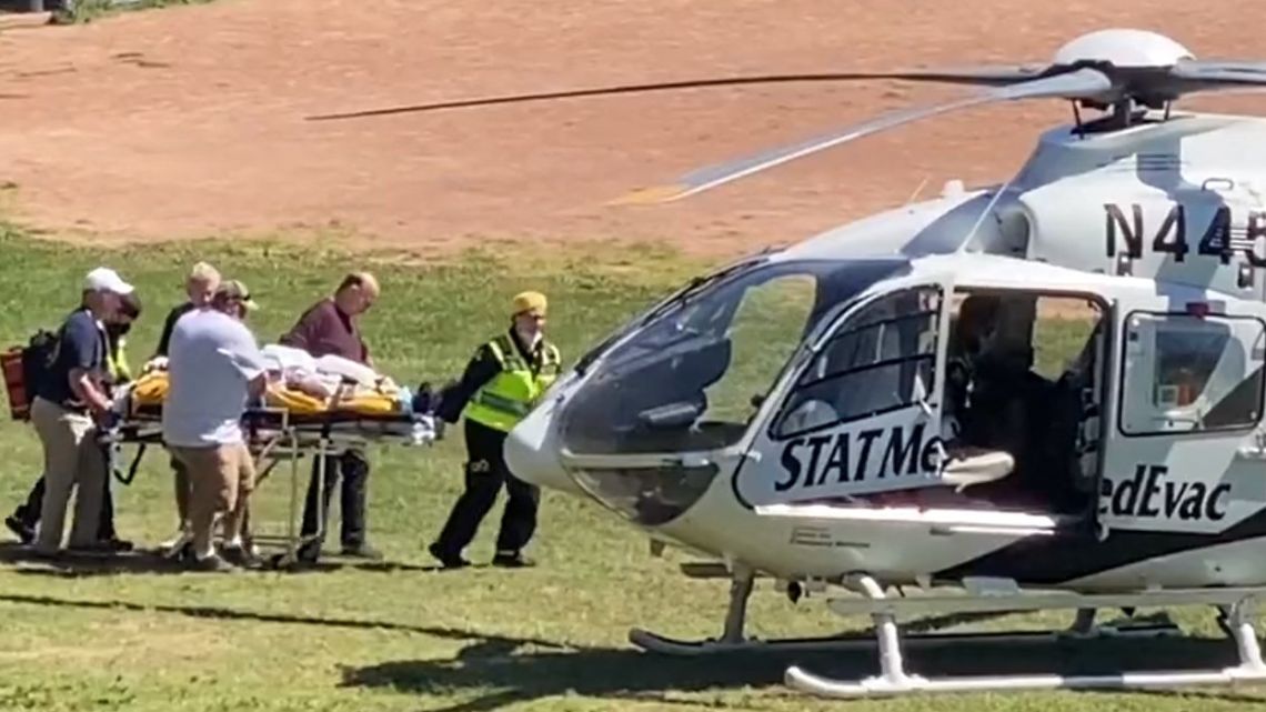 In this frame grab from a video courtesy of Horatio Gates recorded on August 12, 2022, Salman Rushdie is seen being loaded onto a medical evacuation helicopter near the Chautauqua Institution after being stabbed in the neck while speaking on stage in Chautauqua, New York. Rushdie, whose controversial writings made him the target of a fatwa that forced him into hiding, was stabbed in the neck by an attacker on stage Friday in western New York state, according to New York State Police. The attacker is in custody.