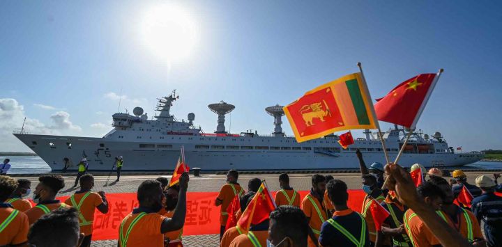 Los trabajadores ondean las banderas nacionales de China y Sri Lanka a la llegada del buque de investigación y estudio de China, el Yuan Wang 5. Ishara S. KODIKARA / AFP.