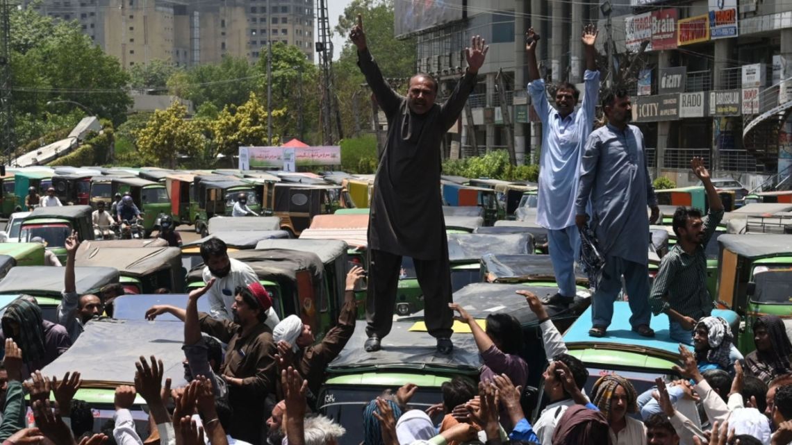 Autorickshaw drivers shout slogans during an anti-government demonstration to protest against inflation and fuel price hikes in Lahore, Pakistan, on June 3, 2022.