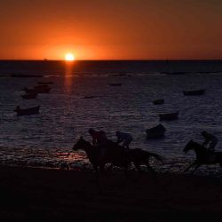 Jockeys corren a lo largo de una playa durante las carreras anuales de caballos en la playa en Sanlúcar de Barrameda, cerca de Cádiz. CRISTINA QUICLER / AFP. | Foto:AFP