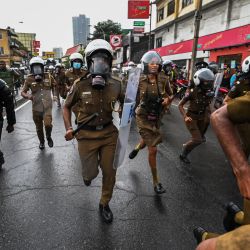 Policías corren mientras estudiantes universitarios y manifestantes protestan contra el gobierno de Sri Lanka y por la liberación de los líderes estudiantiles en Colombo. | Foto:ISHARA S. KODIKARA / AFP