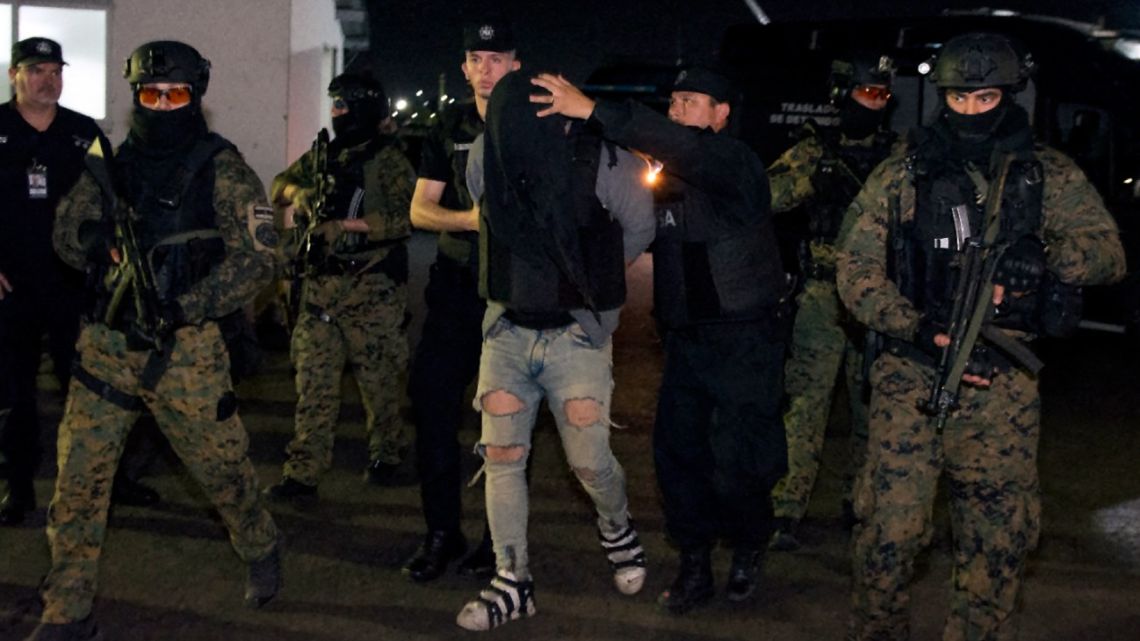 Handout pictures released on September 7, 2022, by Argentina's Airport Security Police (PSA) of Fernando André Sabag Montiel being escorted by PSA members in Buenos Aires, on September 6, 2022.