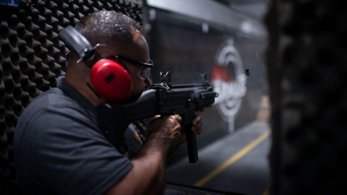 A man shoots during a practice session at the Mil Armas Shooting Club in the city of Nova Iguaçu, Rio de Janeiro State, Brazil on July 28, 2022.
