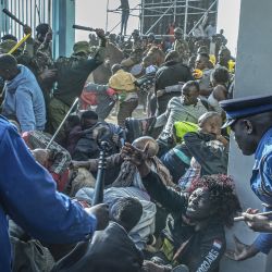 Una mujer pide ayuda mientras las fuerzas de seguridad kenianas intervienen durante una estampida en la entrada del Centro Deportivo Internacional Moi Kasarani en Nairobi, Kenia, antes de la ceremonia de investidura de William Ruto. | Foto:Tony Karumba / AFP