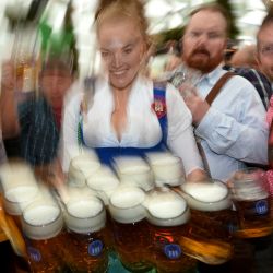 Una camarera lleva jarras de cerveza en una carpa durante la inauguración del festival de la cerveza Oktoberfest en el recinto ferial de Theresienwiese en Múnich, sur de Alemania. | Foto:Christof Stache / AFP