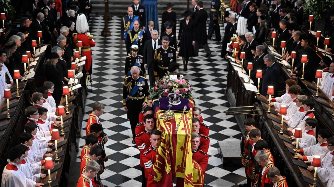 Britain's King Charles III, Britain's Camilla, Queen Consort, Britain's Princess Anne, Princess Royal, Vice Admiral Timothy Laurence, Britain's Prince Andrew, Duke of York, Britain's Prince Edward, Earl of Wessex, Britain's Sophie, Countess of Wessex, Britain's Prince William, Prince of Wales, Britain's Prince George of Wales, Britain's Catherine, Princess of Wales, Britain's Prince Harry, Duke of Sussex and Meghan, Duchess of Sussex walk behind the coffin of Britain's Queen Elizabeth II as they leave Westminster Abbey in London on September 19, 2022, after the State Funeral Service for Britain's Queen Elizabeth II. 