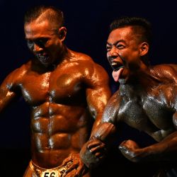 Atletas de culturismo compiten en el Campeonato Nacional de Culturismo y Deportes Físicos de Myanmar en Yangon. | Foto:SAI AUNG MAIN / AFP