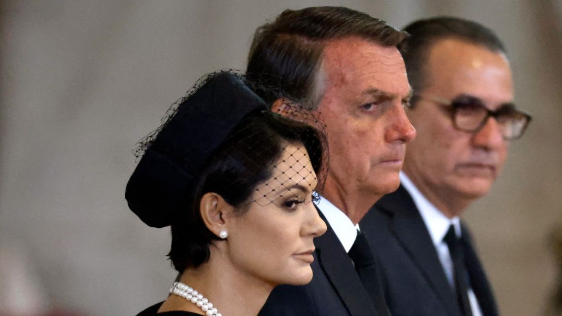 Brazil's President Jair Bolsonaro and his wife Michelle Bolsonaro pays their respects as they pass the coffin of Queen Elizabeth II, as it Lies in State inside Westminster Hall, at the Palace of Westminster in London on September 18, 2022.