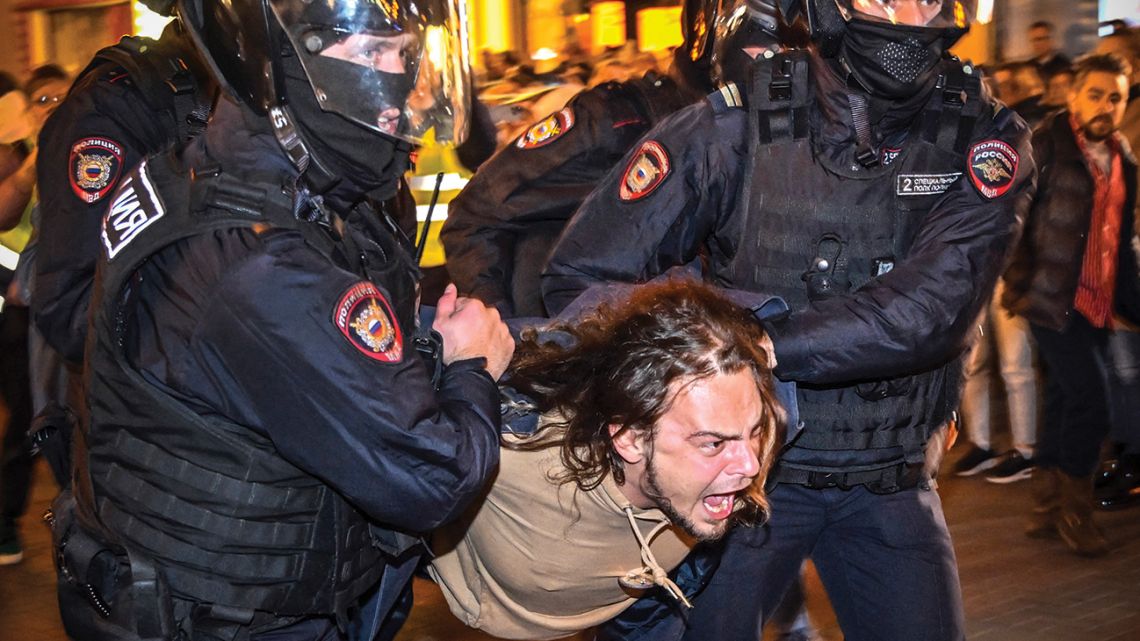 Police officers detain a man following calls to protest against partial mobilisation announced by Russian President, in Moscow, on September 21, 2022.