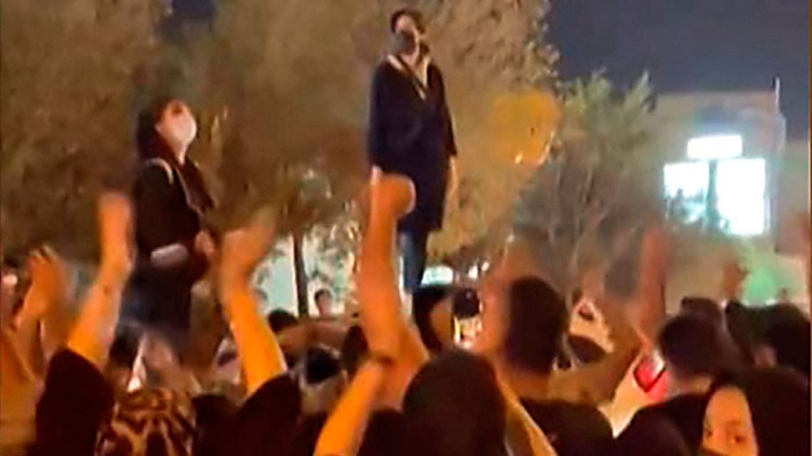 This grab taken from a UGC video shows Iranian women protesting in a street in the central city of Yazd, on September 26, 2022, as they rally following the death of 22-year-old Kurdish woman Mahsa Amini after her arrest for allegedly breaching Iran's strict rules on hijab headscarves and modest clothing. 