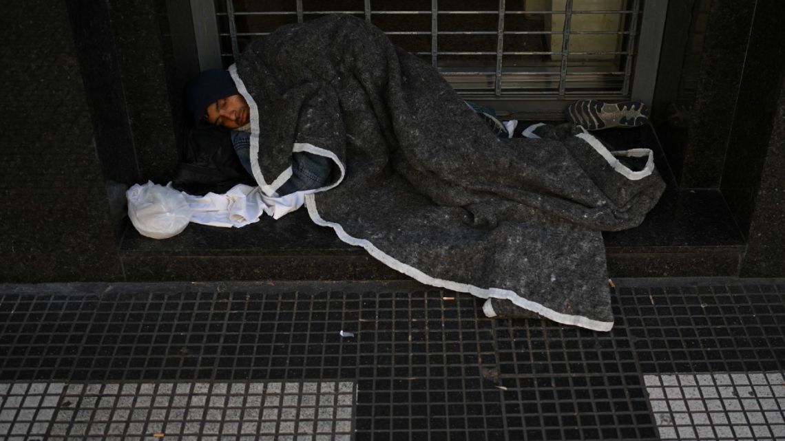 A homeless man sleeps in a street of Buenos Aires on September 28, 2022. 