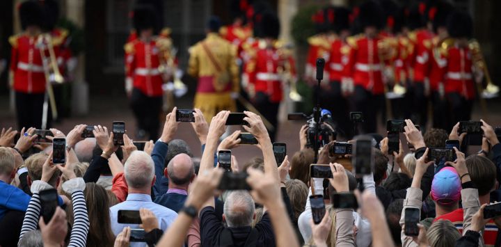 Miembros del público escuchan la proclamación primaria del nuevo Rey de Gran Bretaña, el Rey Carlos III, desde el balcón Friary Court del Palacio de St James en Londres.