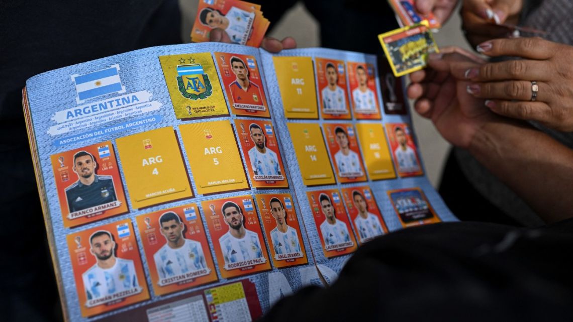 A man exchanges Panini World Cup football stickers at Parque Rivadivia in Buenos Aires on September 18, 2022.