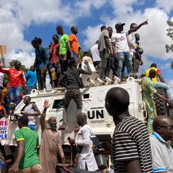 Los manifestantes se sitúan encima de un vehículo blindado de Unitend Nation mientras se manifiestan en Uagadugú. - Las fuerzas de seguridad dispararon gases lacrimógenos para dispersar a los manifestantes frente a la embajada de Francia en la capital de Burkina Faso, mientras los disturbios se mantienen en la empobrecida nación de África Occidental tras la afirmación de un segundo golpe de Estado este año. | Foto:AFP