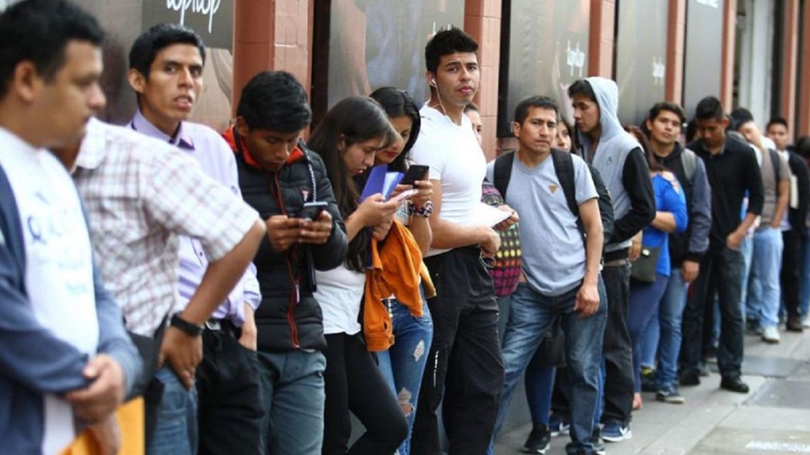 People line up outside a job employment centre in Buenos Aires.