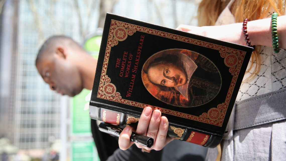 A woman reads a book by William Shakespeare at a bookshop in New York City.