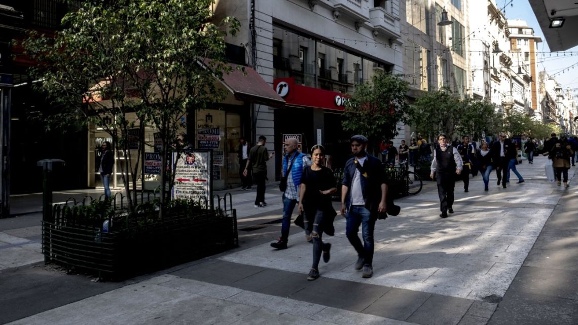 Pedestrians walk on Calle Florida in downtown Buenos Aires.