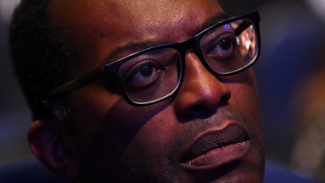 Britain's then-Chancellor of the Exchequer Kwasi Kwarteng listens as Britain's Prime Minister Liz Truss (unseen) delivers her keynote address on the final day of the annual Conservative Party Conference in Birmingham, central England, on October 5, 2022. 