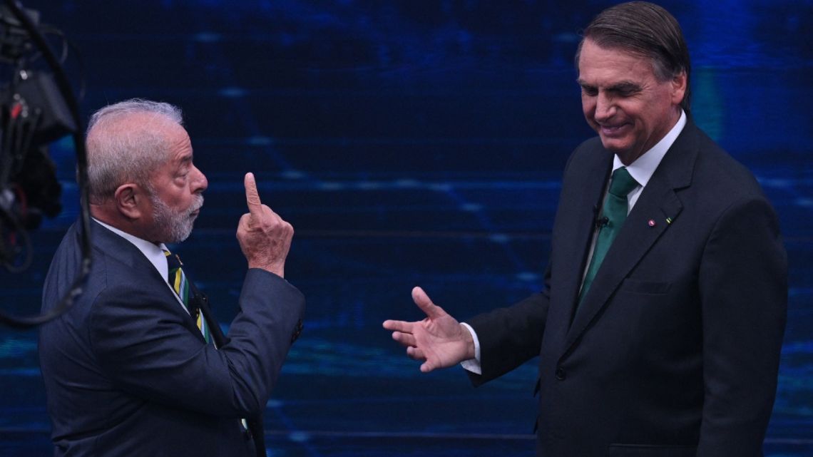 Brazilian former president (2003-2010) and presidential candidate for the leftist Workers Party, Luiz Inácio Lula da Silva, and current president Jair Bolsonaro gesture during a televised presidential debate in Sao Paulo, Brazil, on October 16, 2022.