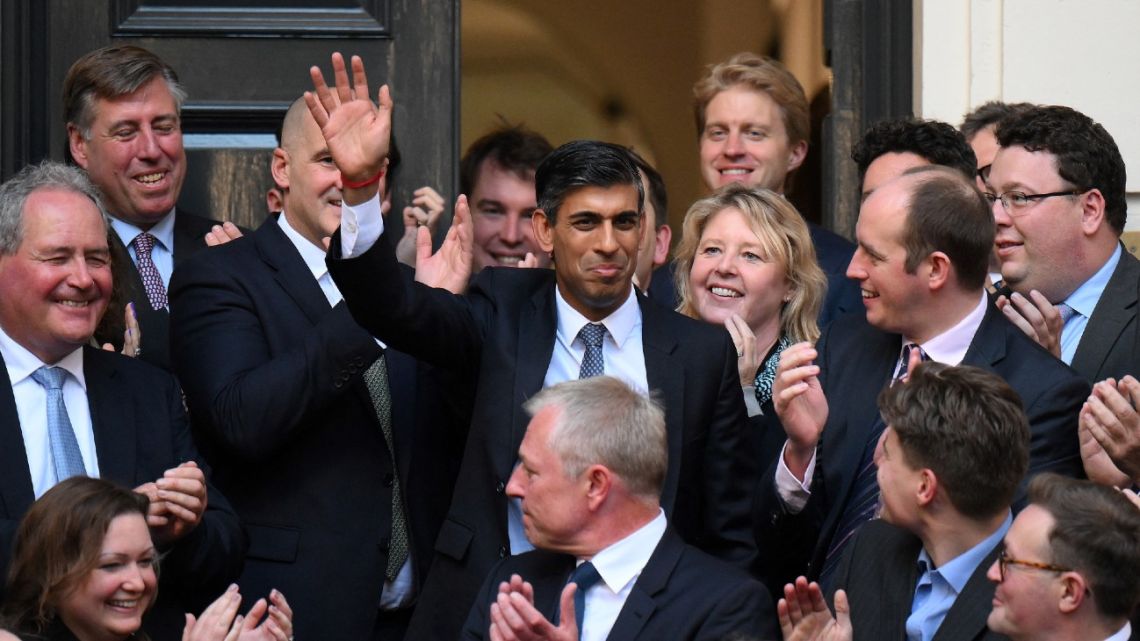 New Conservative Party leader and incoming prime minister Rishi Sunak (centre) waves as he arrives at Conservative Party Headquarters in central London having been announced as the winner of the Conservative Party leadership contest, on October 24, 2022. Britain's next prime minister, former finance chief Rishi Sunak, inherits a UK economy that was headed for recession even before the recent turmoil triggered by Liz Truss. 