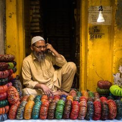 Un vendedor de brazaletes espera a los clientes en un mercado mayorista de brazaletes en Firozabad. - La ciudad industrial india de Firozabad lleva más de 200 años fabricando brazaletes de cristal y suministrando millones de estos brazaletes ornamentales, que llevan las mujeres en su vida cotidiana y se venden como regalos en festivales como Diwali y las bodas, por toda la India. | Foto:XAVIER GALIANA / AFP