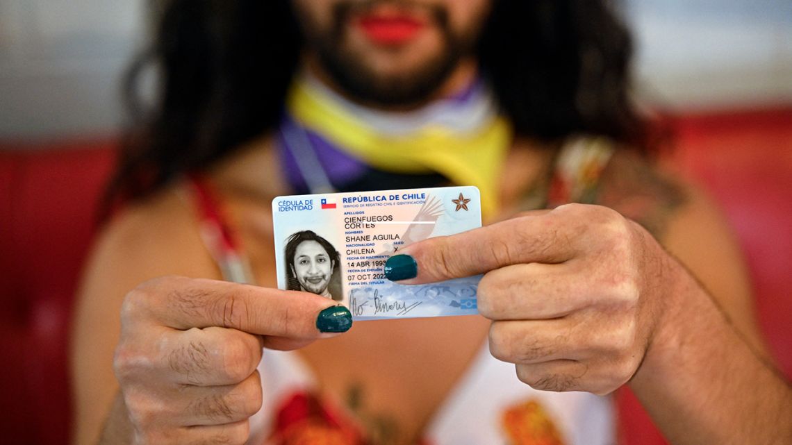 Shane Cienfuegos shows their identity card during an interview with AFP at their house in Santiago on October 23, 2022. Shane Cienfuegos is the first person to receive an identity card with an 'X' in the gender field in Chile. Shane identifies as a non-binary, trans person, which means that their gender identity does not correspond to the archetype of the predominant genders, escaping from the male-female gender binomial. 