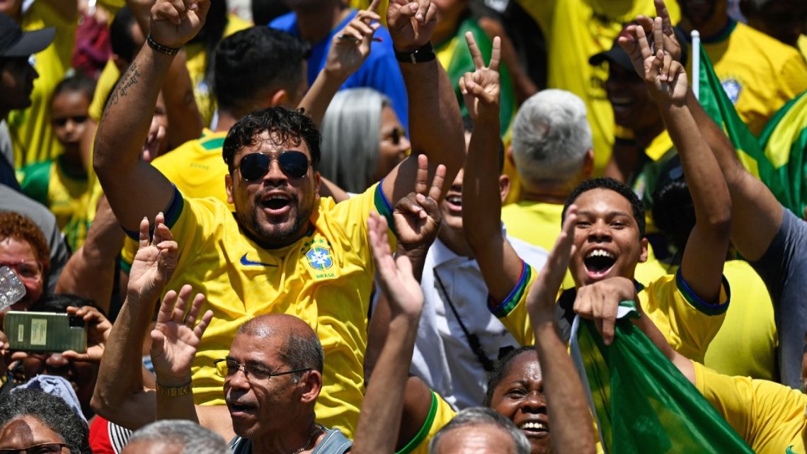 Supporters of the Brazilian president and re-election candidate Jair Bolsonaro cheer at a campaign rally ahead of the nation's October 30th run-off election.