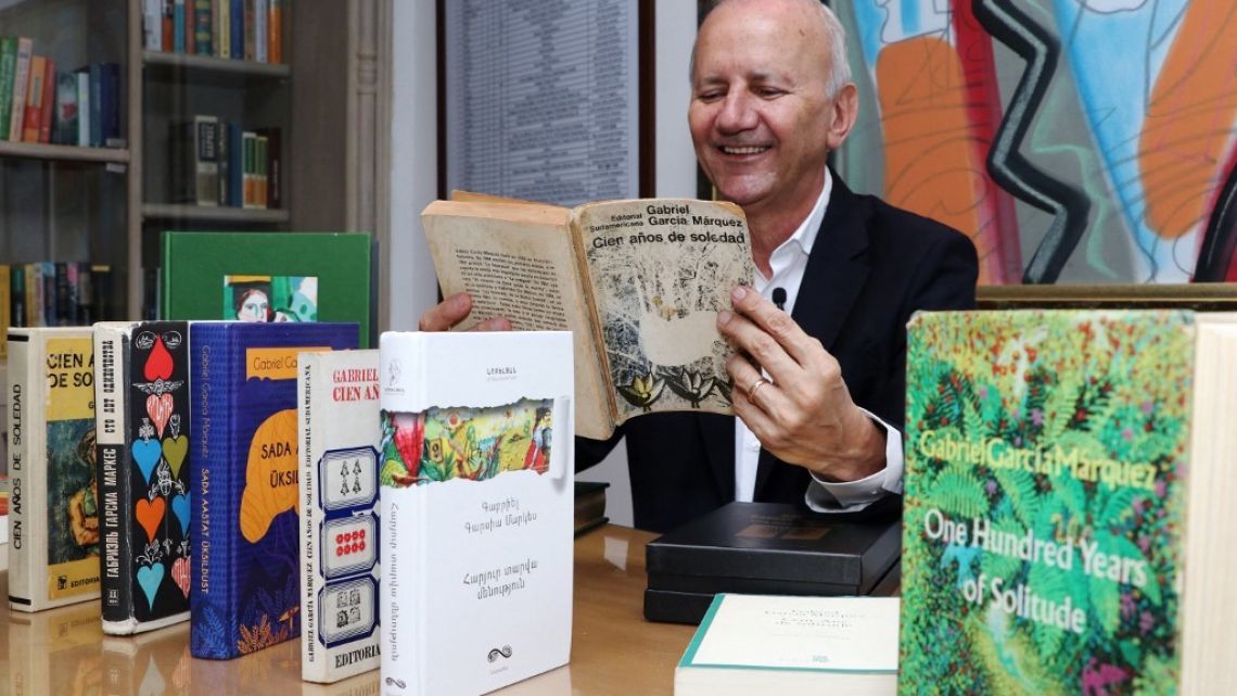 Colombian collector Jorge Salazar holds a Spanish edition of “One Hundred Years of Solitude,” by Colombian Nobel Prize in Literature Gabriel Garcia Marquez, during an interview with AFP at his house in Armenia, Quindio department, Colombia, on October 23, 2022.