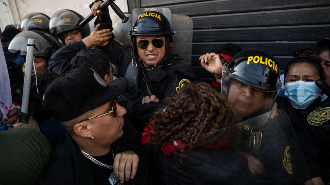 People opposing the government of Peruvian President Pedro Castillo face the police during a demonstration to demand his resignation in Lima, on November 5, 2022.