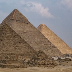 La pirámide de Menkaure (Menkheres), la pirámide de Khafre (Kefrén) y la Gran Pirámide de Khufu (Keops) se iluminan a diferentes niveles por el paso de las nubes en la necrópolis de las pirámides de Giza en las afueras de la ciudad gemela de la capital de Egipto, El Cairo, Egipto. | Foto:AMIR MAKAR / AFP