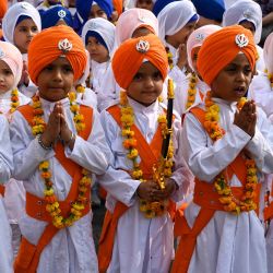 Escolares vestidos como hombres santos sijs conocidos como Panj Pyare, gesticulan durante una procesión religiosa en la víspera del aniversario del nacimiento de Guru Nanak Dev, en el Templo Dorado de Amritsar. | Foto:Narinder Nanu / AFP