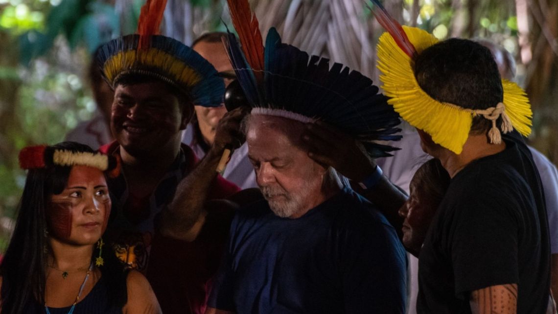 Luiz Inácio Lula da Silva is presented with a headdress during an event with the indigenous community at Parque dos Igarapés, Belén, Pará state, Brazil, on Friday, September 2, 2022.