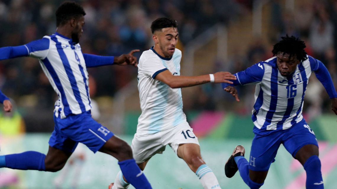 In this file photo taken on August 10, 2019, Argentina’s Nicolás González battles for the ball with Honduras’ players Elison David Rivas Mejia (L) and Jose Antonio Garcia Robledo (R) during the Men's Football Gold Medal Match between Argentina and Honduras at the Lima 2019 Pan-American Games in Lima.