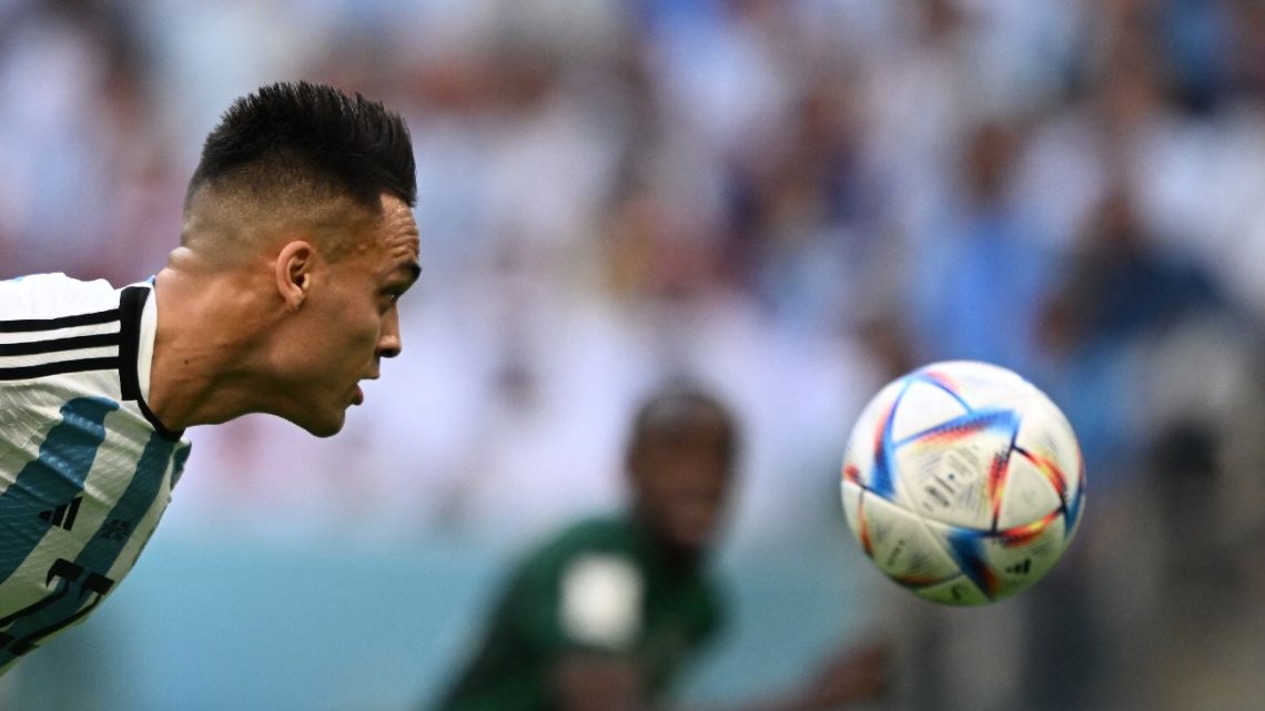 Argentina's forward #22 Lautaro Martínez challenges for the ball during the Qatar 2022 World Cup Group C football match between Argentina and Saudi Arabia at the Lusail Stadium in Lusail, north of Doha on November 22, 2022. 