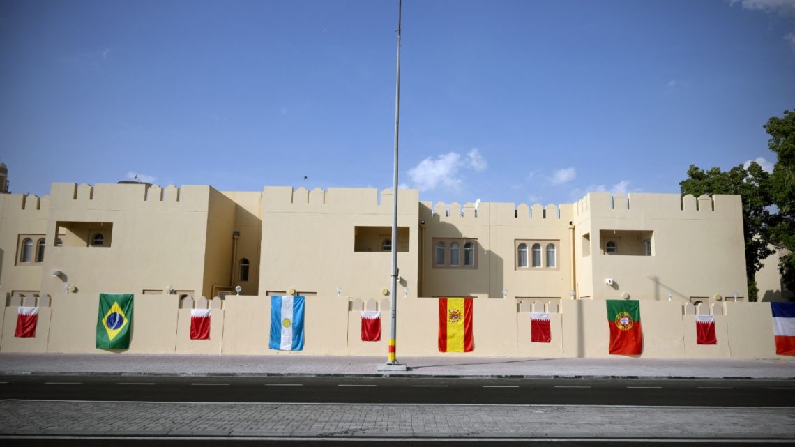 The flags of Brazil, Argentina, Spain and Portugal displayed along an empty street, ahead of the Qatar 2022 World Cup football tournament.
