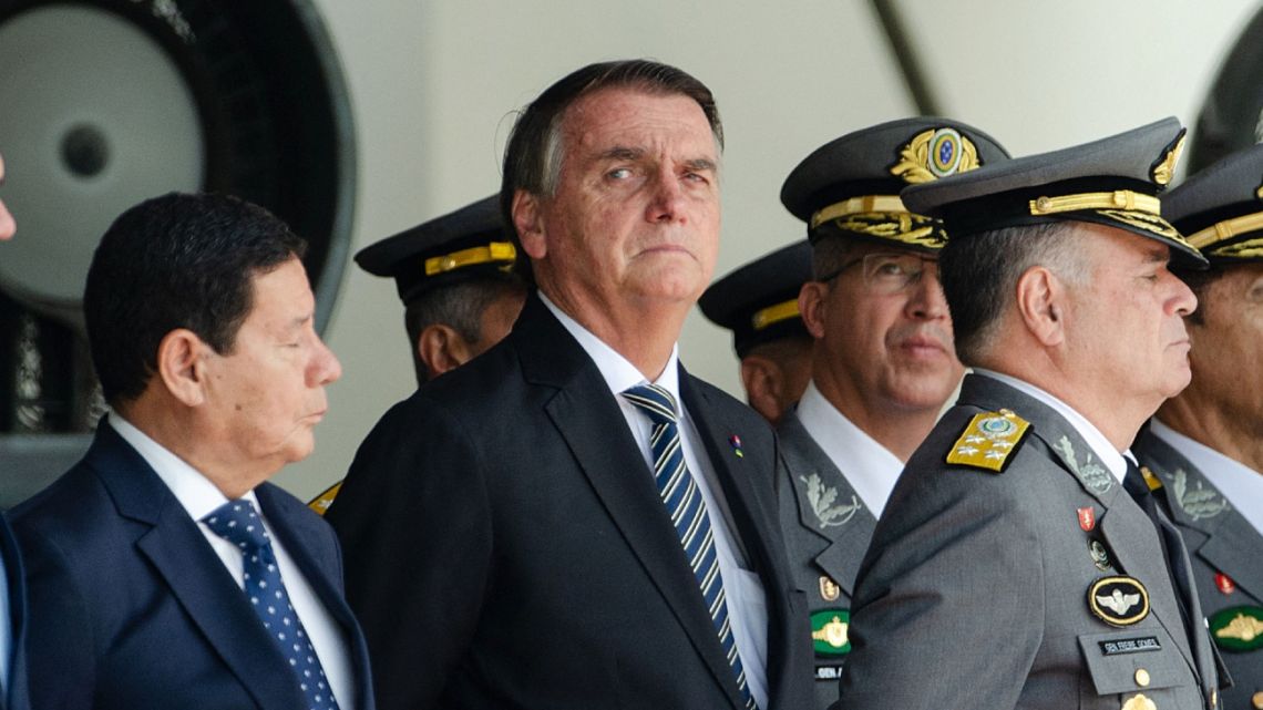 Brazilian President Jair Bolsonaro (C) attends next his Vice President Hamilton Mourao (L) and Commander of the Army General Marco Antonio Freire Gomes a graduation ceremony for cadets at the Agulhas Negras Military Academy in Resende, Rio de Janeiro State, Brazil.