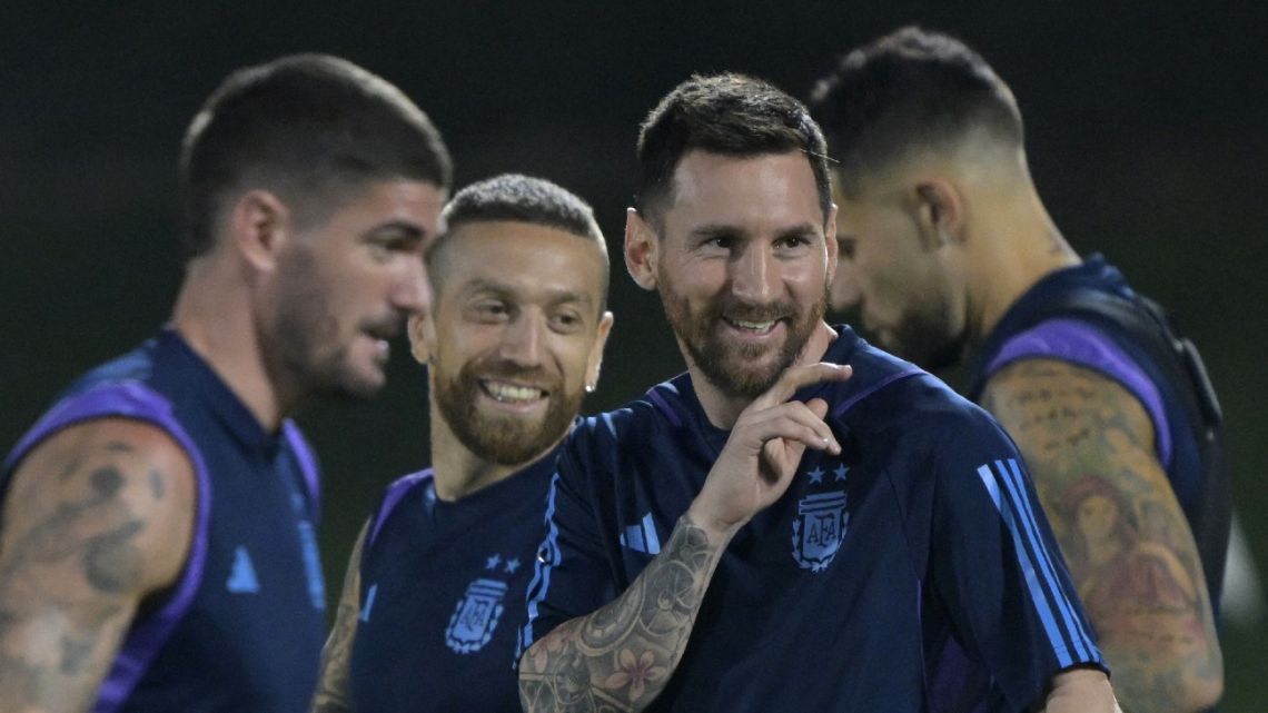 Argentina's forward Lionel Messi smiles next to midfielder Alejandro Gómez, midfielder Rodrigo De Paul and midfielder Leandro Paredes during a training session at Qatar University in Doha on November 29, 2022, on the eve of the Qatar 2022 World Cup football tournament match against Poland. 