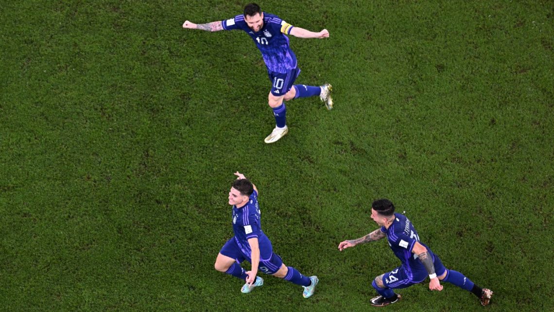 Argentina's forward #9 Julián Álvarez celebrates with #10 Lionel Messi and midfielder #24 Enzo Fernández after scoring his team's second goal during the Qatar 2022 World Cup Group C football match between Poland and Argentina at Stadium 974 in Doha on November 30, 2022. 