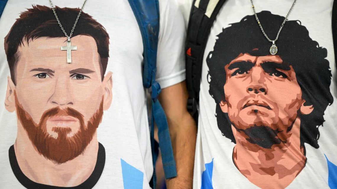 Argentina supporters wearing t-shirts depicting Lionel Messi and Diego Maradona at the Qatar 2022 World Cup Group C football match between Poland and Argentina at Stadium 974 in Doha on November 30, 2022. 
