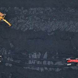 Esta foto aérea muestra excavadoras transfiriendo carbón en un puerto de Lianyungang, en la provincia oriental china de Jiangsu. | Foto:AFP